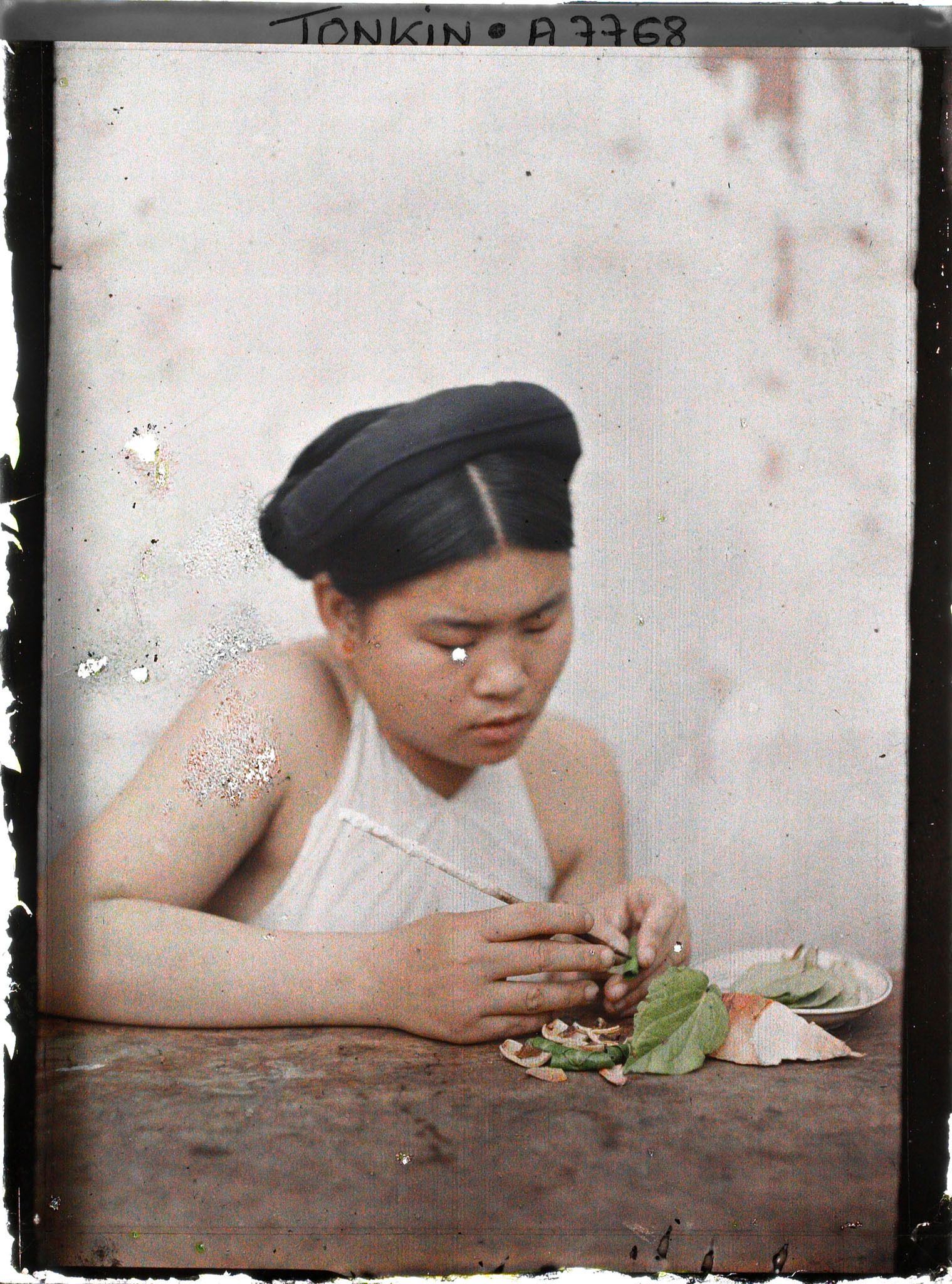 Image représentant Une jeune femme effectuant les phases finales de la confection d'une chique de bétel