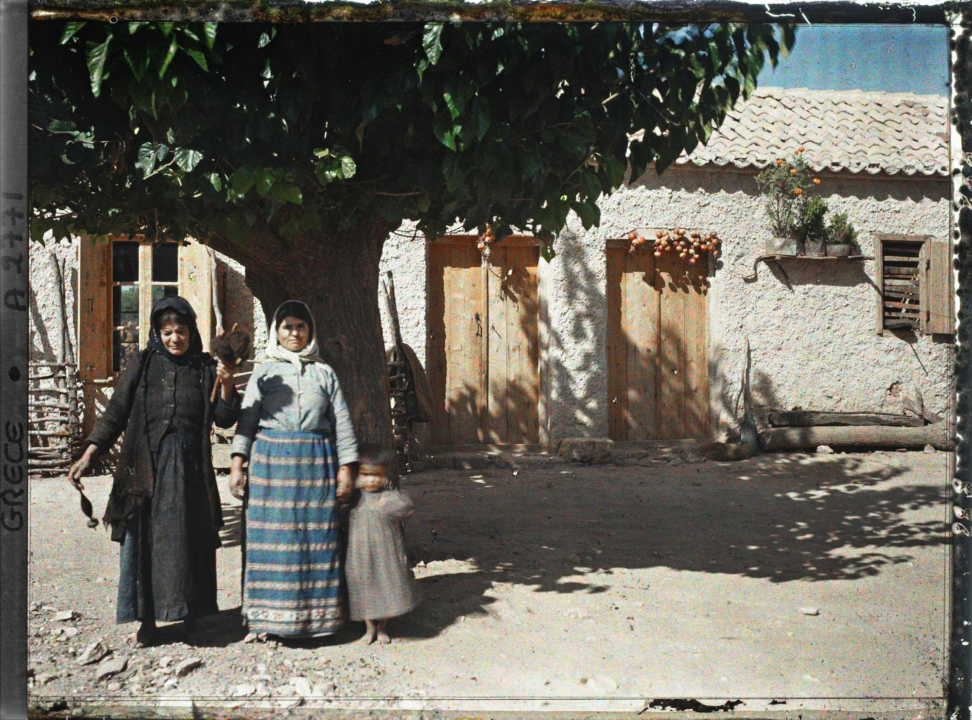 Image représentant Deux villageoises (d'origine albanaise) et une fillette dans une rue ou une cour de ferme