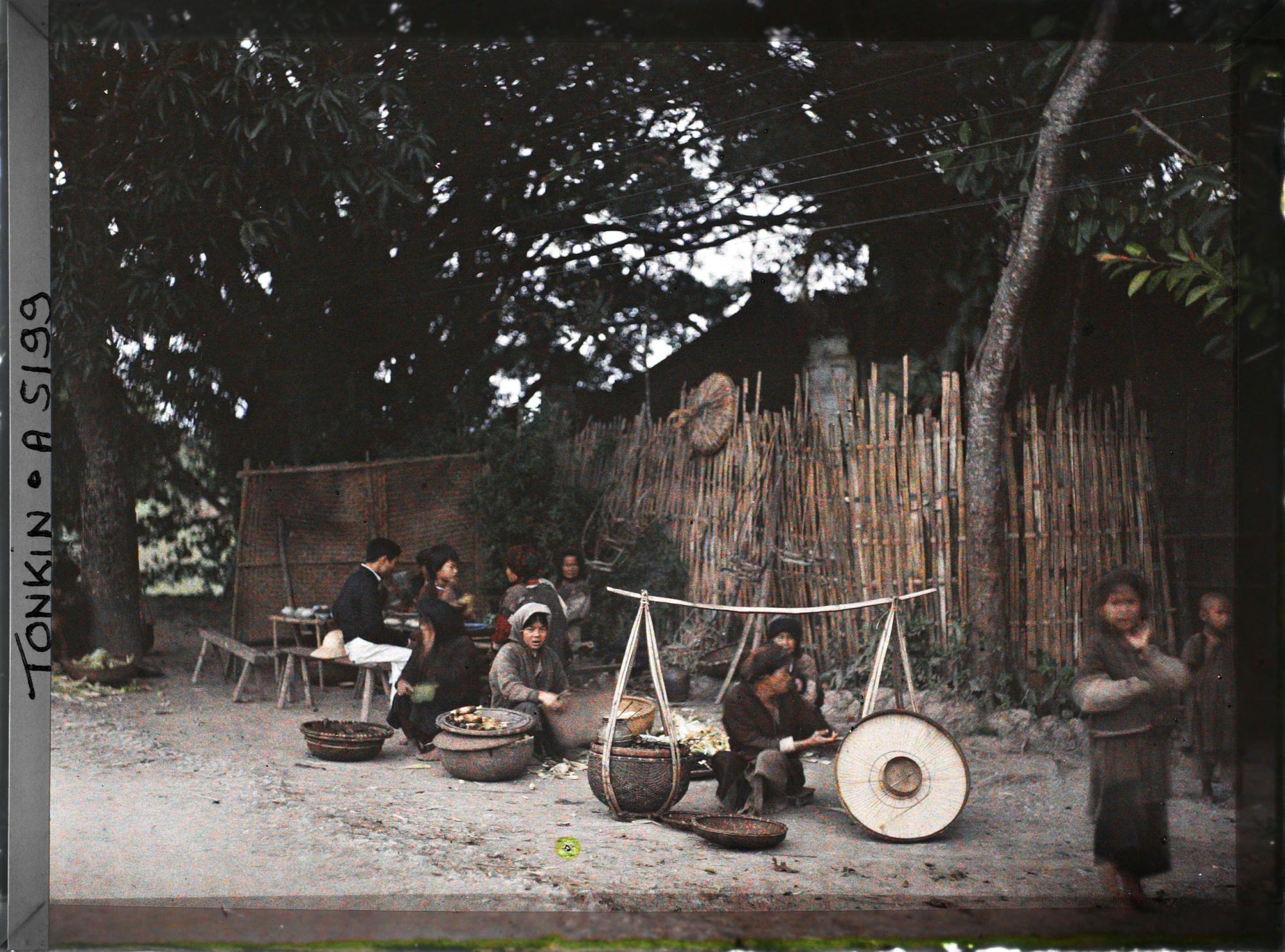 Image représentant Des marchands ambulants avec leurs palanches devant un restaurant en plein air