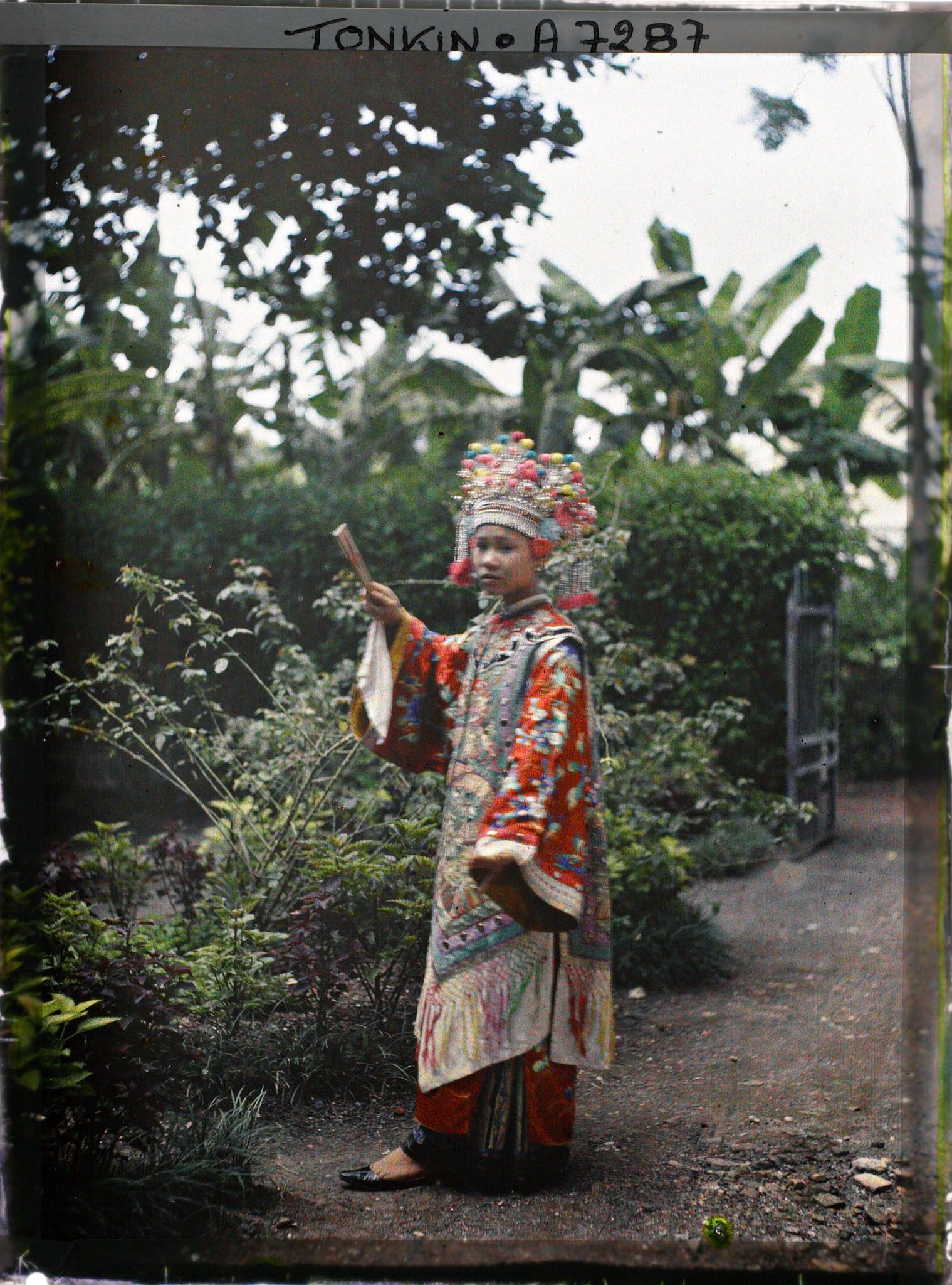 Image représentant Une actrice du Théâtre Saïgonnais, en costume de scène, dans un jardin