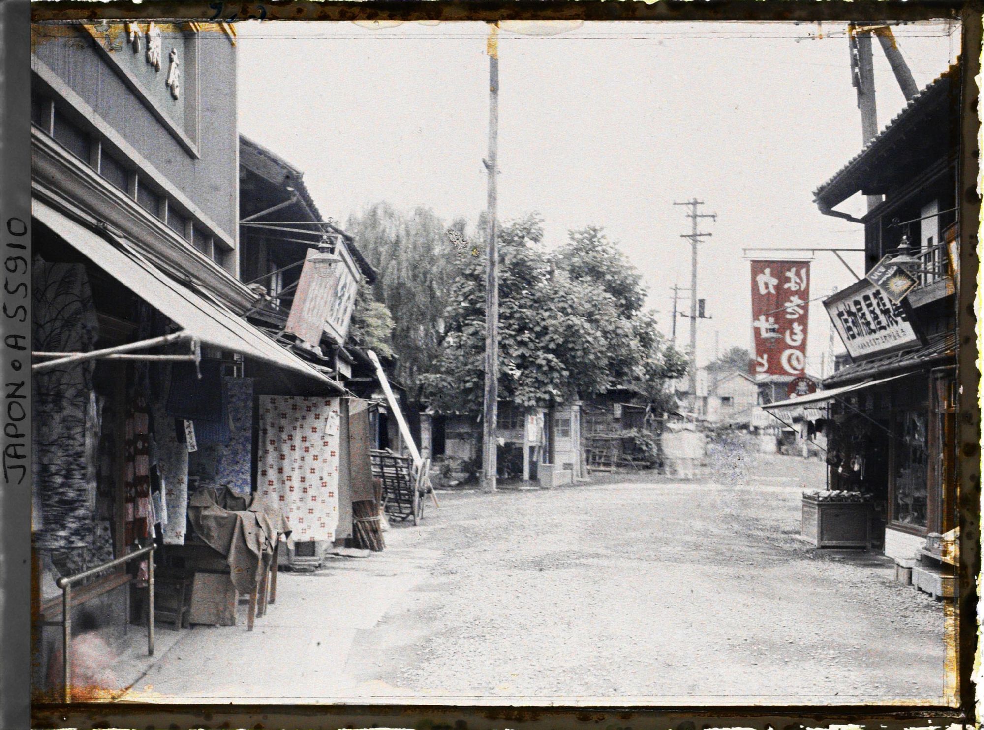 Image représentant Une rue du quartier d'Akasaka (?), au premier plan, une boutique de tissus, à droite, un marchand de chaussures