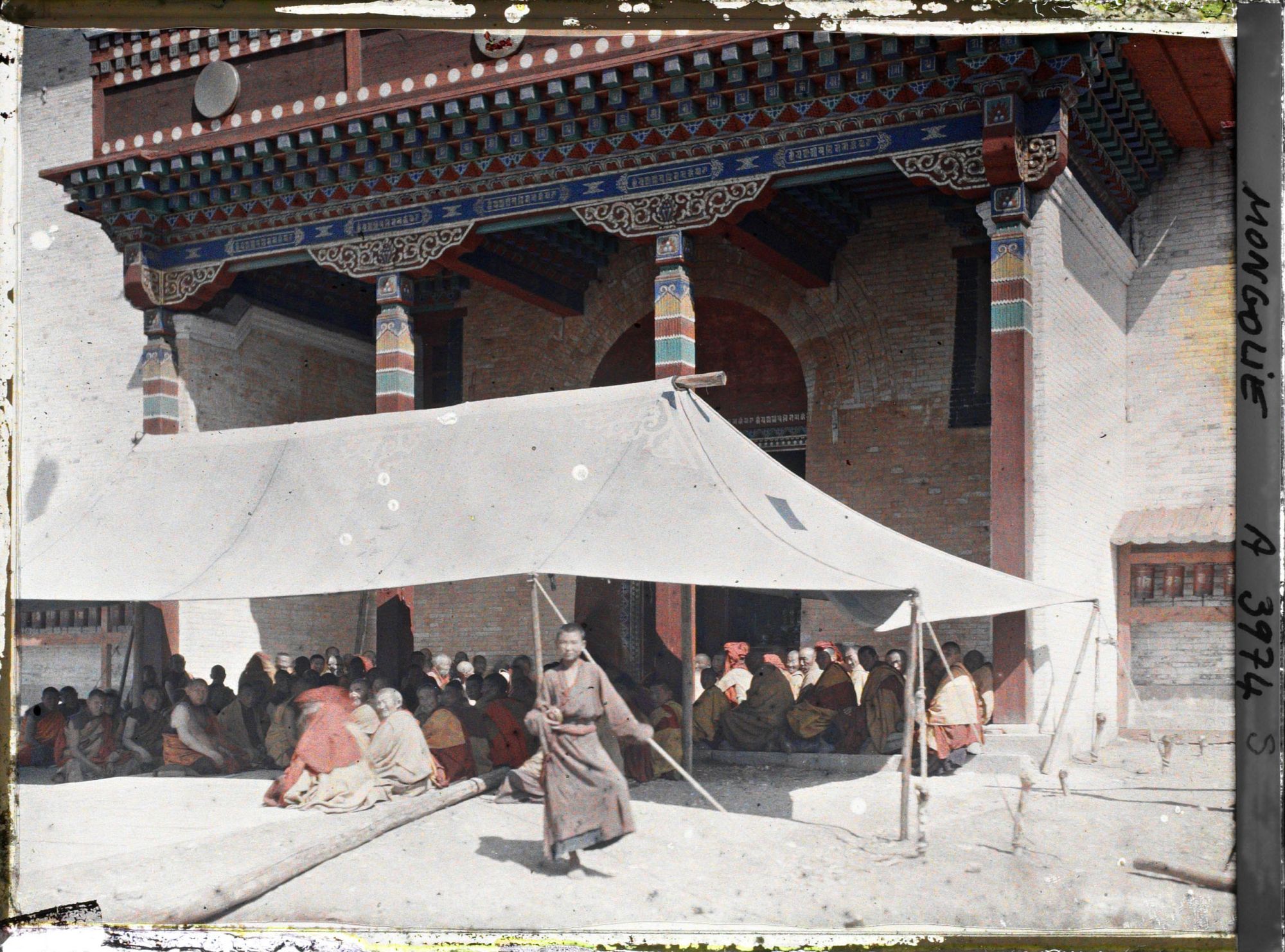 Image représentant Une prière collective devant le porche d'entrée du temple Megjid janraiseg, monastère de Gandan