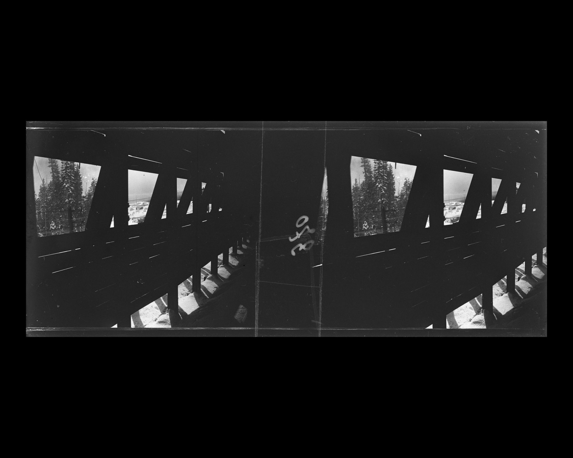 Image représentant le paysage enneigé vu à travers le tunnel de planches