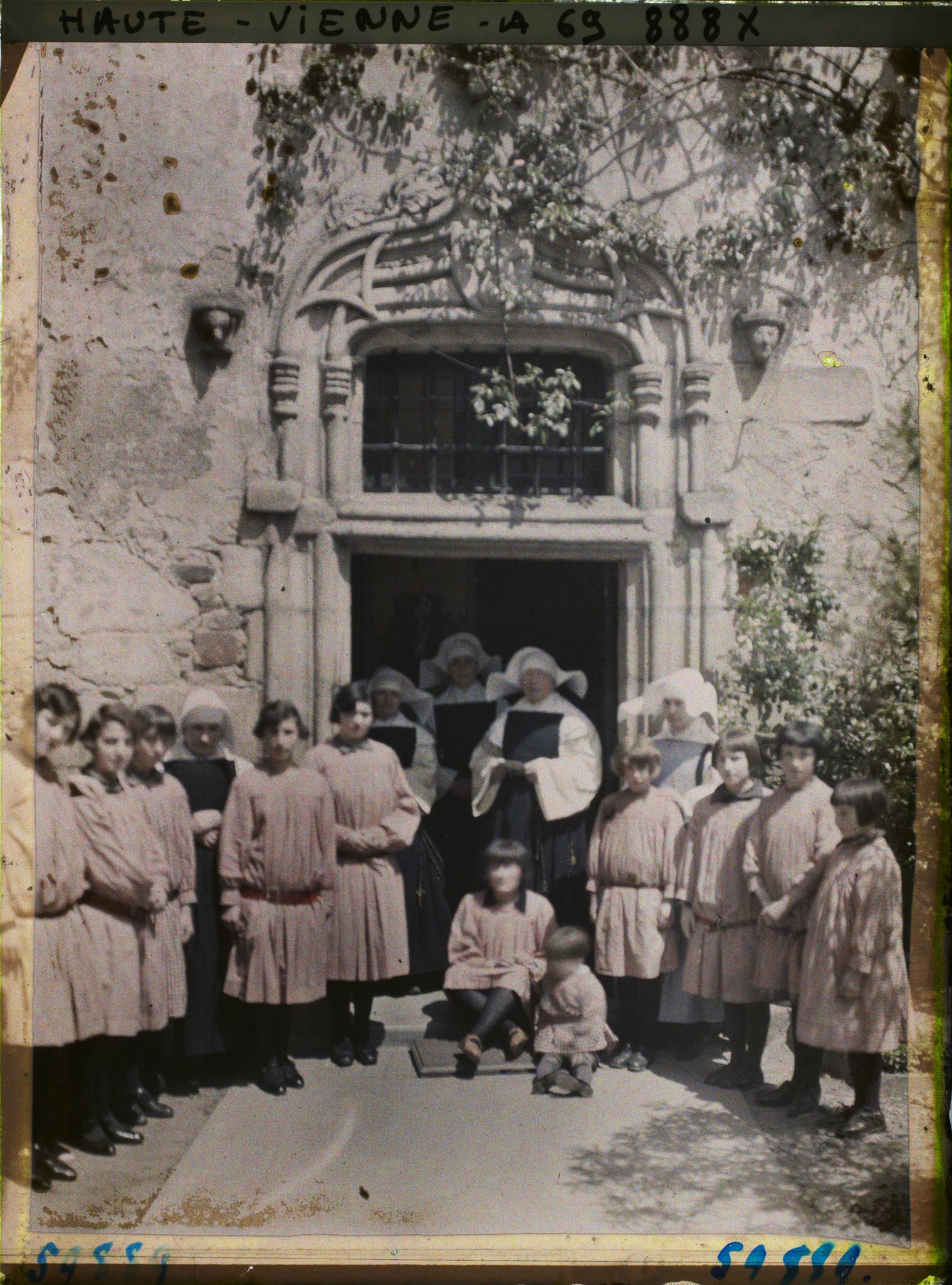 Image représentant Un groupe de jeunes filles et de soeurs posant devant l'orphelinat du couvent des Clarisses