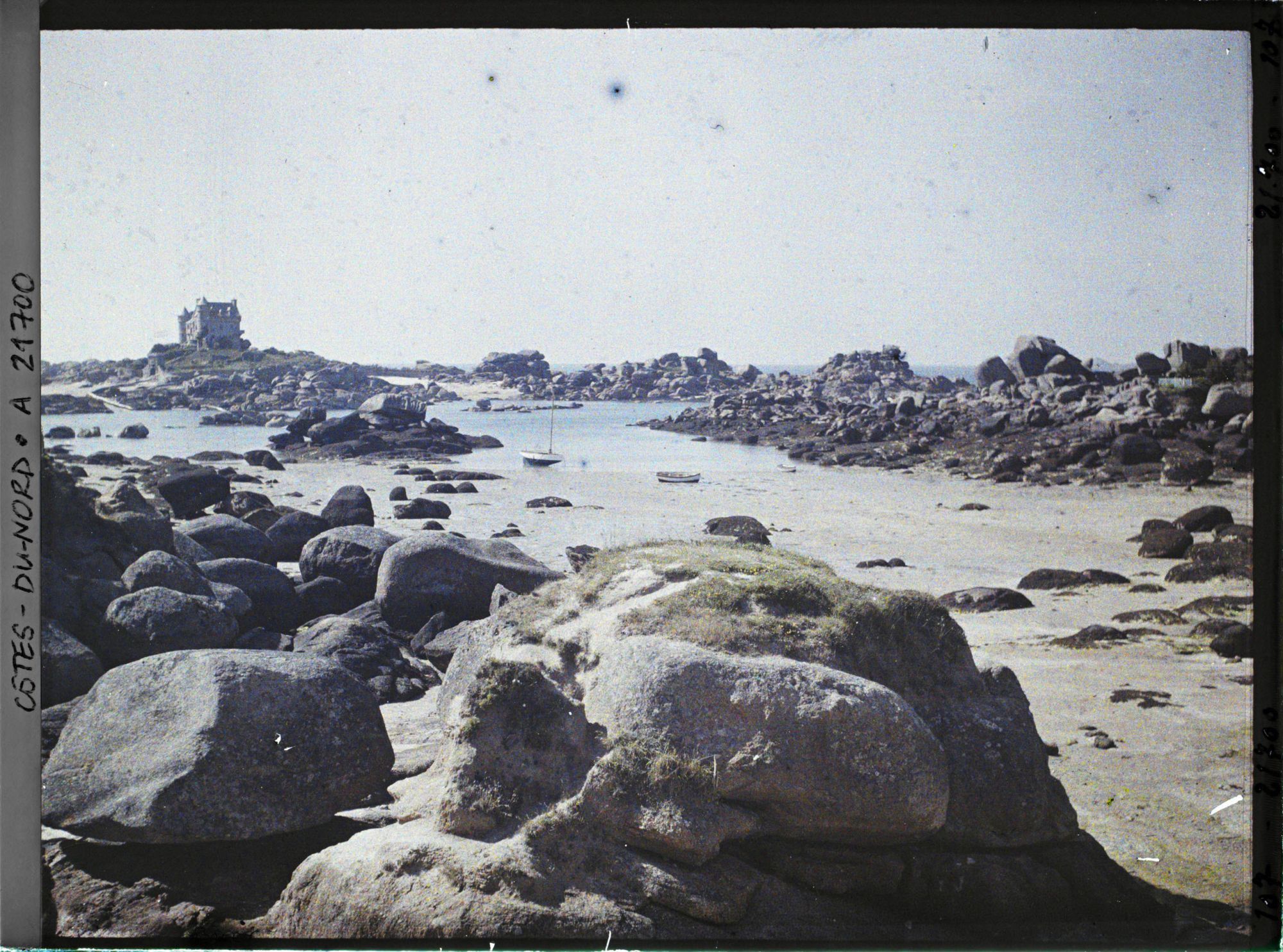 Image représentant Les rochers de la plage de Saint-Guirec avec à l'arrière-plan le château de Costaéres