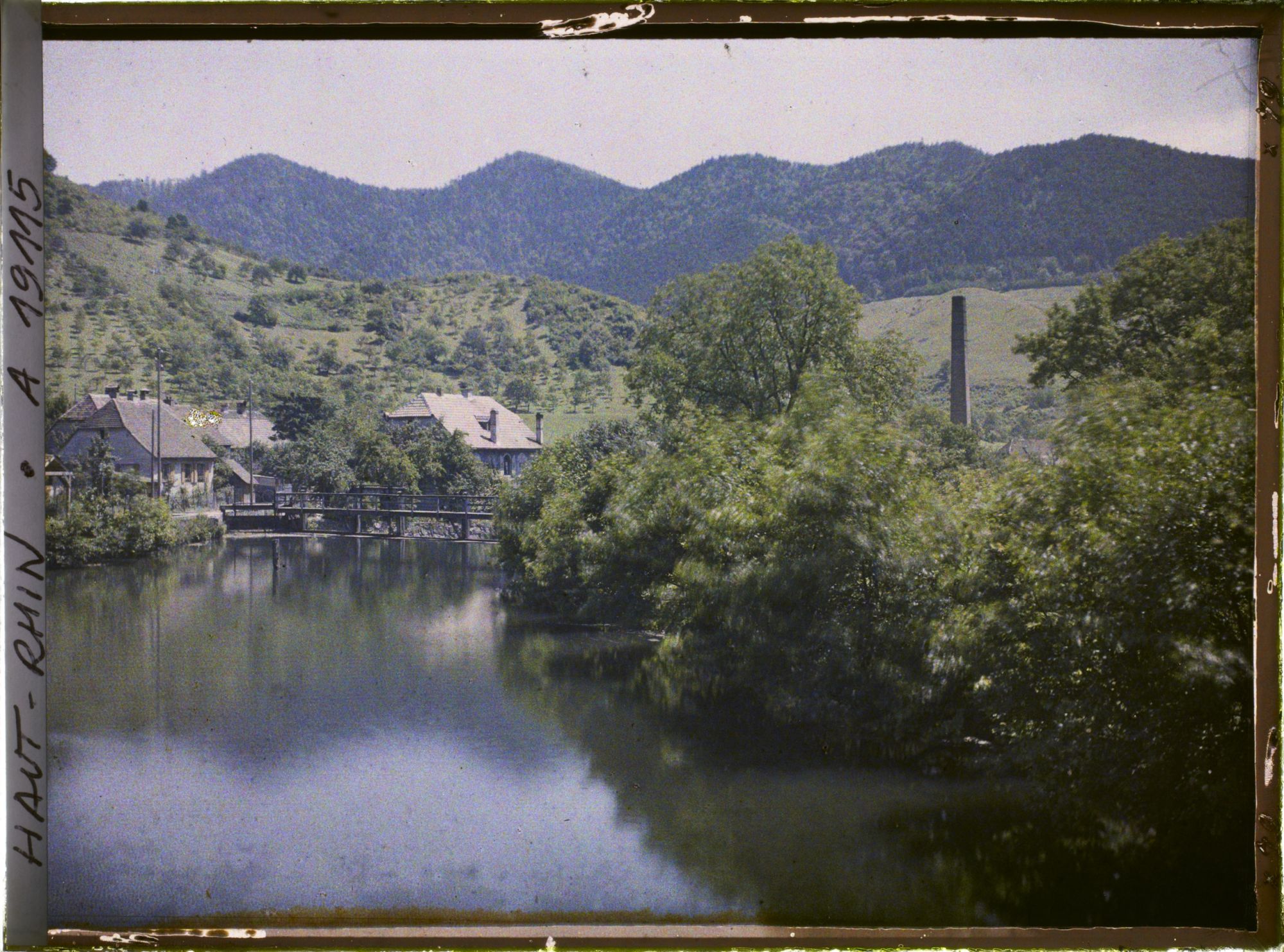 Image représentant France, Wiler, Les bords de la Thur vers l'aval, la cheminée d'une filature dans les arbres