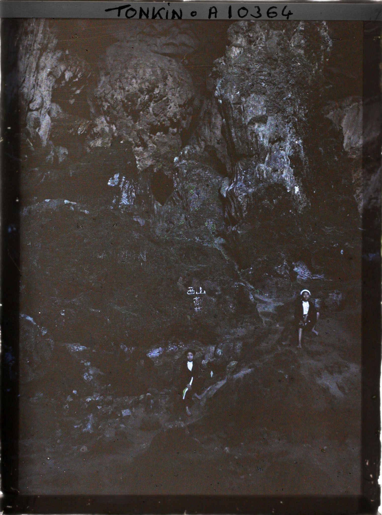 Image représentant Deux jeunes filles assises sur les rochers, à l'intérieur de la Grotte des Merveilles