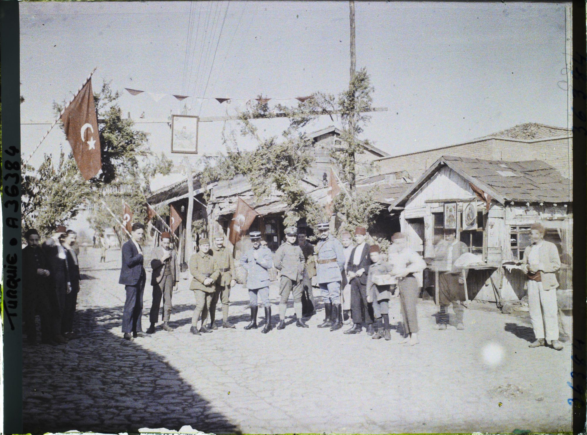 Image représentant Groupe d'enfants et d'hommes civils et militaires (français et britannique ?) dans une rue pavoisée