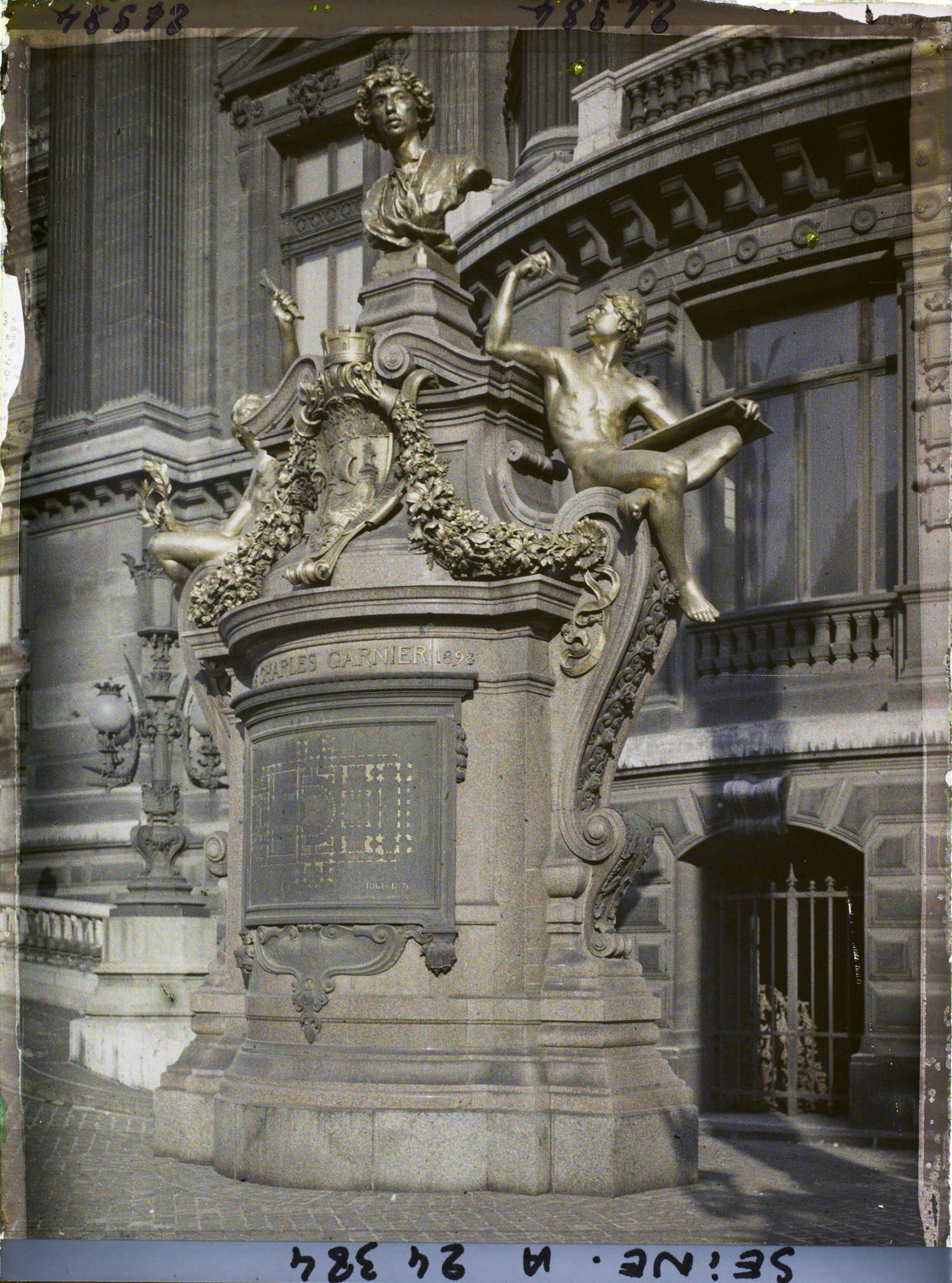 Image représentant Le monument à la mémoire de Charles Garnier, en contrebas de la rampe devant l'Opéra place Charles-Garnier