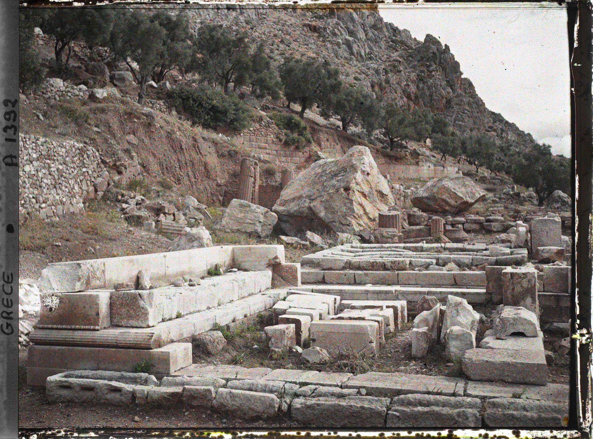 Image représentant Sanctuaire de Marmaria. A droite du Tholos, le Trésor Ionique de Marseille (au premier plan), puis un autre Trésor (Dorique)