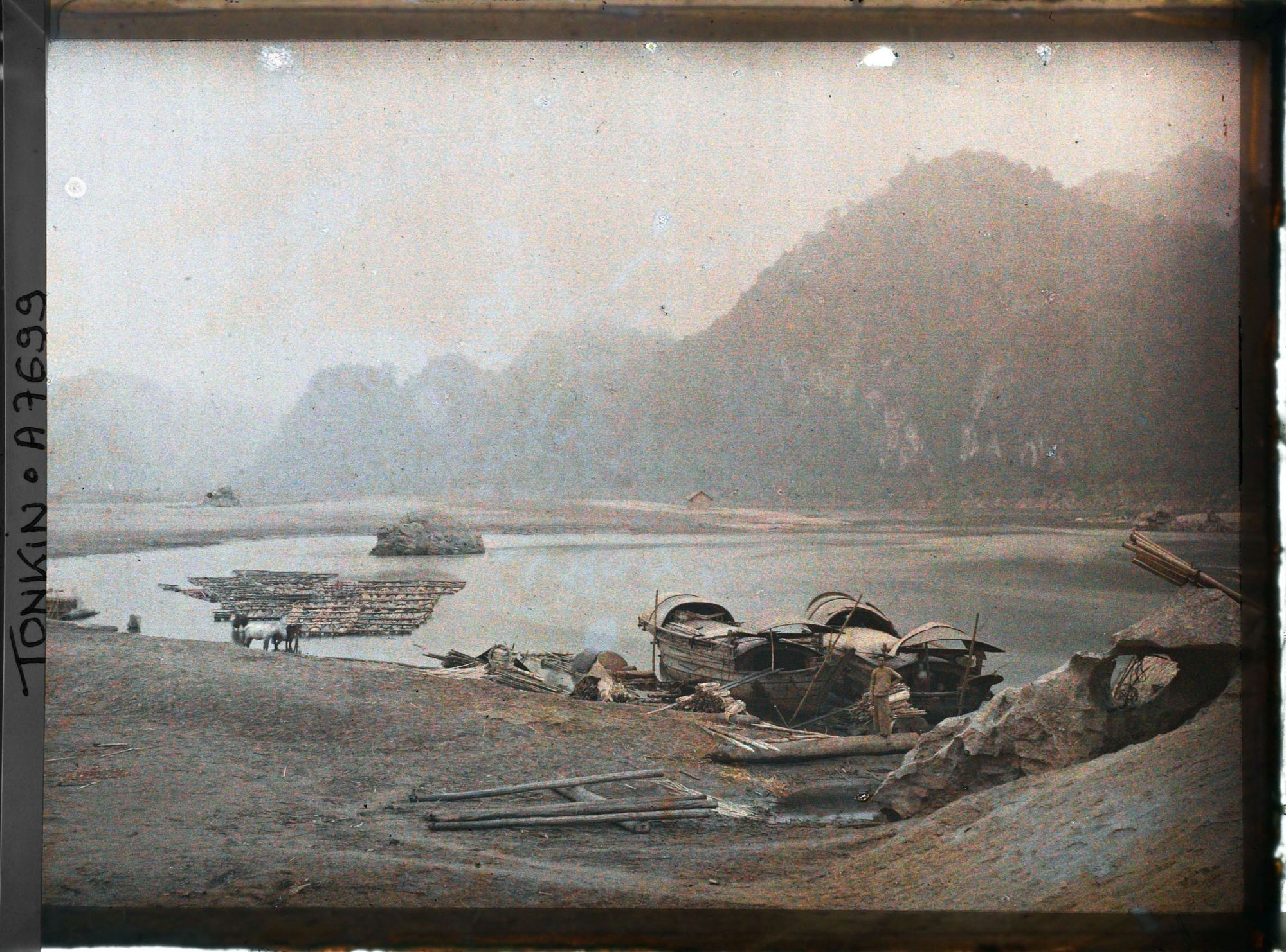 Image représentant Des sampans amarrés, juste en aval du barrage de rochers entravant le cours de la rivière Noire