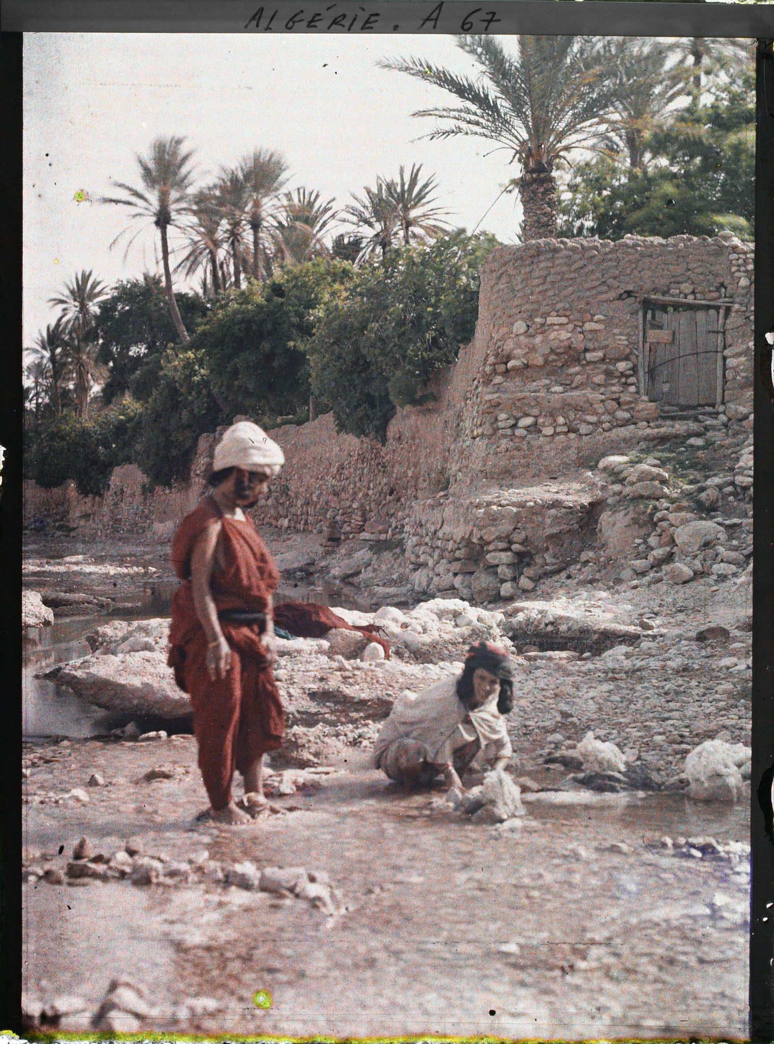 Image représentant Deux femmes, appartenant probablement à la tribu des Ouled Naïl, au bord de l'oued