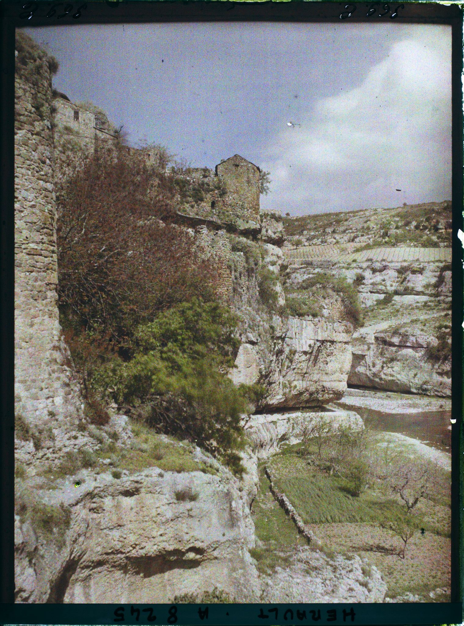 Image représentant La prison à gauche et la maison penchée à l'extrémité du promontoire à droite