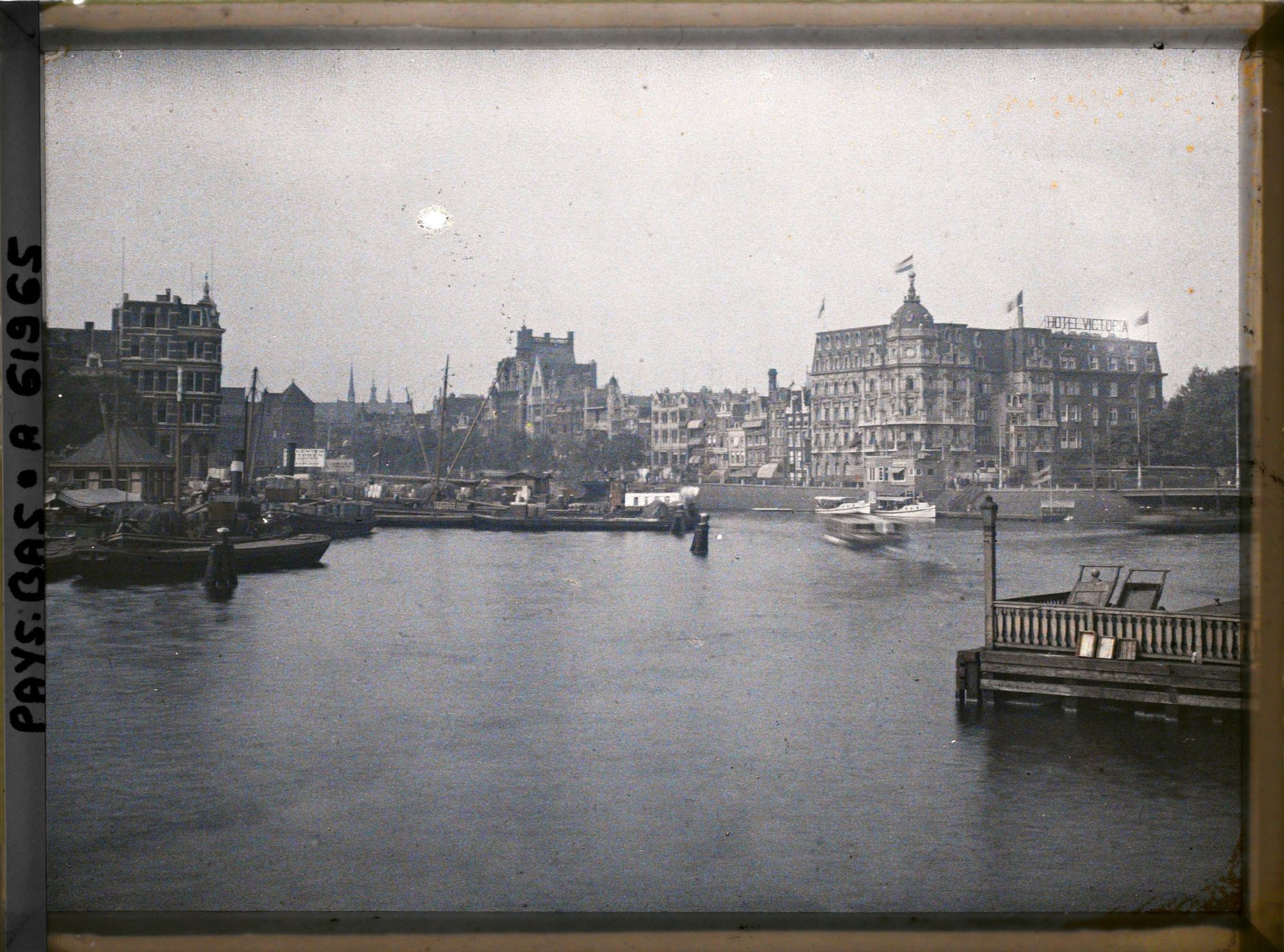 Image représentant L'Open Haven avec à l'arrière-plan le Damrak