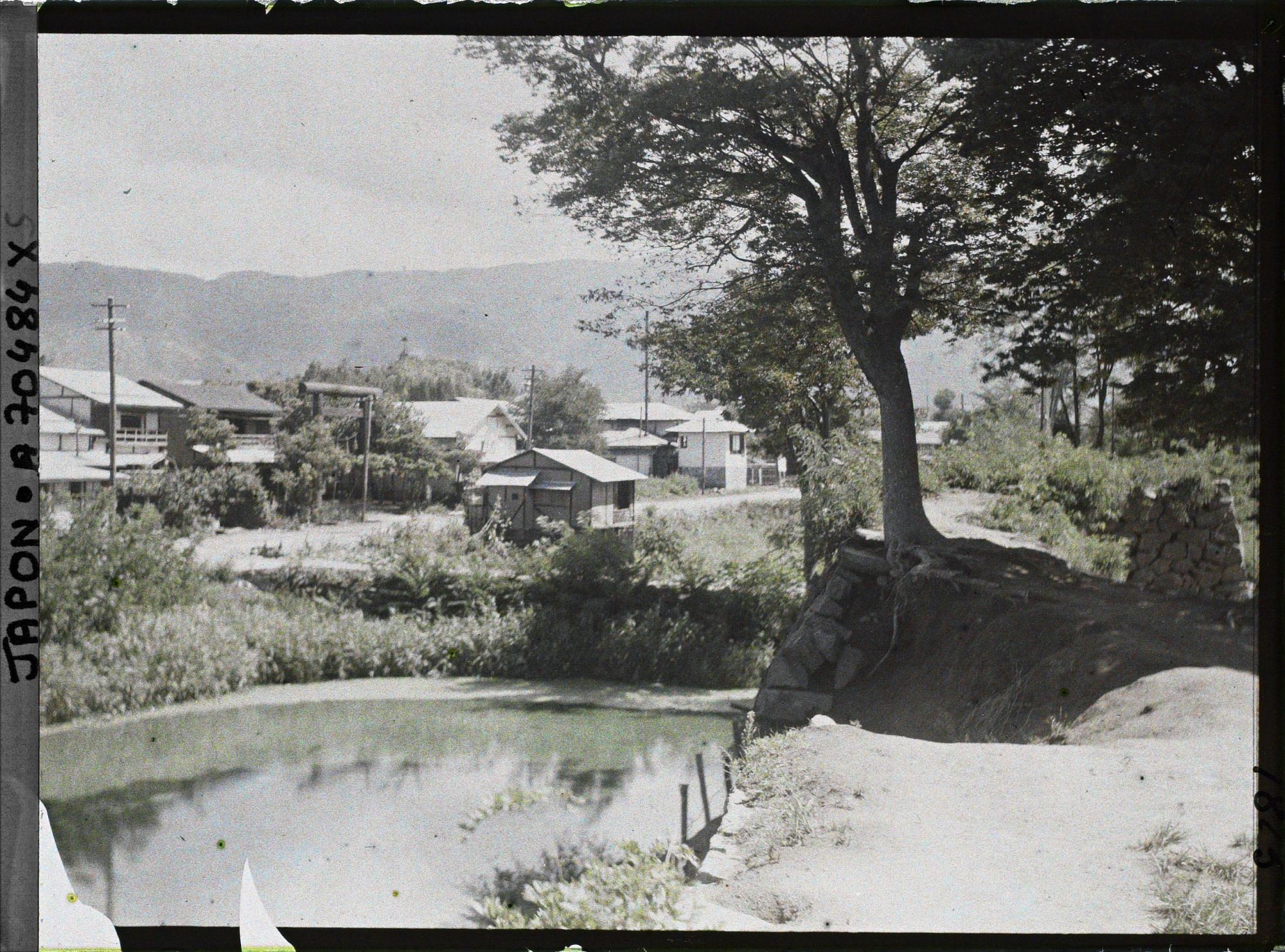 Image représentant Ruines d'anciennes douves ou simple cours d'eau (?) et une partie de la ville