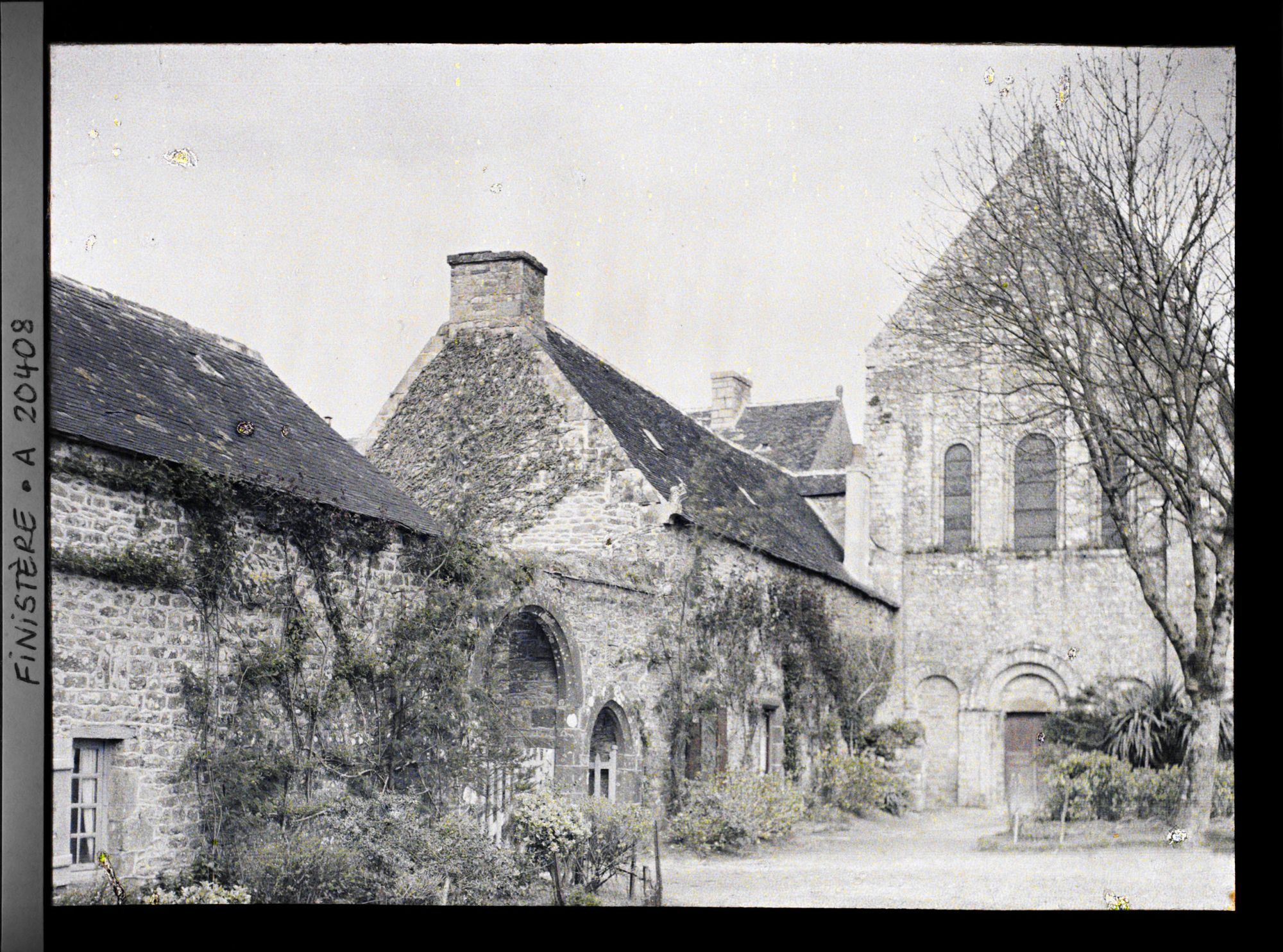 Image représentant Des bâtiments abbatiaux avec l'entrée de l'abbaye et à droite l'église abbatiale Notre-Dame