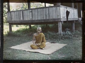 Image représentant Un bonze assis en méditation sur une natte, près de la bonzerie