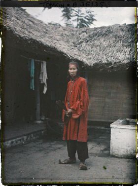 Image représentant Un notable de village en costume de cérémonie à l'occasion d'un mariage, assis dans une cour intérieure