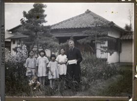 Image représentant Le père Cesselin, missionnaire français, entouré d'un groupe d'enfants vêtus à l'occidentale