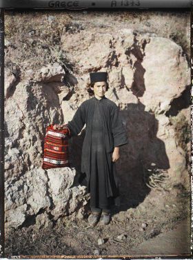 Image représentant Un jeune novice, futur moine orthodoxe (toque, robe et manteau noirs)