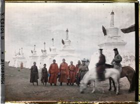 Image représentant Un groupe de lamas près du " mur " de stupa qui marque les limites de Gandan à l'ouest et au nord