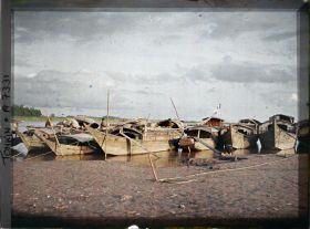 Image représentant Des sampans amarrés aux rives du Fleuve Rouge, l'après midi