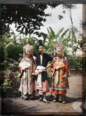 Image représentant Deux actrices et un acteur du Théâtre Saïgonnais, en costume de scène, dans un jardin