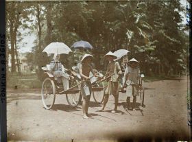 Image représentant Jeunes femmes en pousse-pousse à roues caoutchoutées, dans le jardin botanique