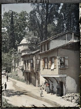 Image représentant Femmes et enfants devant et à la fenêtre d'une maison dans une rue de terre battue