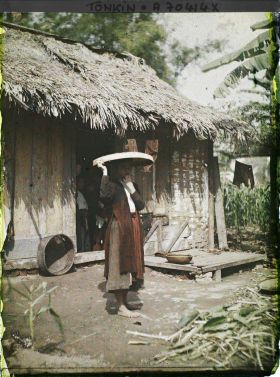 Image représentant Une jeune femme devant une habitation