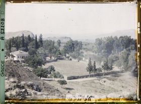 Image représentant Vers la ville et son éperon rocheux au bord du Golfe d'Agolide. Une belle maison et ses palmiers