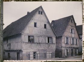 Image représentant France, Marmoutier, Dans la rue qui conduit vers Strasbourg, maison grise et maison rouge.