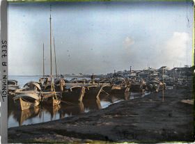 Image représentant Des sampans au soleil couchant amarrés aux rives du Fleuve Rouge