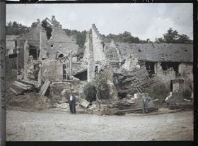 Image représentant Deux hommes devant des maisons détruites