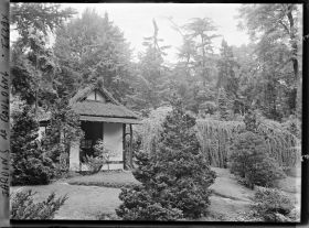 Image représentant Façade principale du pavillon de thé du " village japonais ", dans un écrin arboré