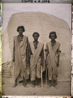 Image représentant Trois hommes  null bishari posant devant une habitation