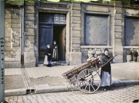 Image représentant Femme avec une charreton (charrette) devant une habitation, rue Libergier