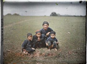 Image représentant Une famille thaï, vêtue de bleu, dans les plaines près des grottes de Ky-lu'a